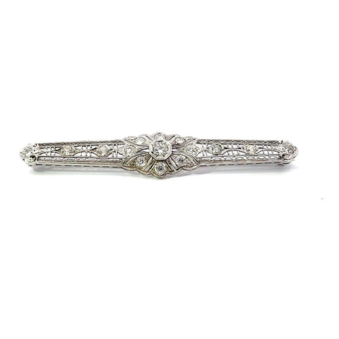 A 14k white gold bar pin with Art Deco filigree design and old European cut diamonds.